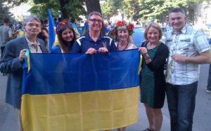 Canadian MP Peggy Nash (right) with Canadian MPs Ted Opitz (centre) and James Bezan (far right) in Kharkiv, while pro-Ukrainian rally just passed by